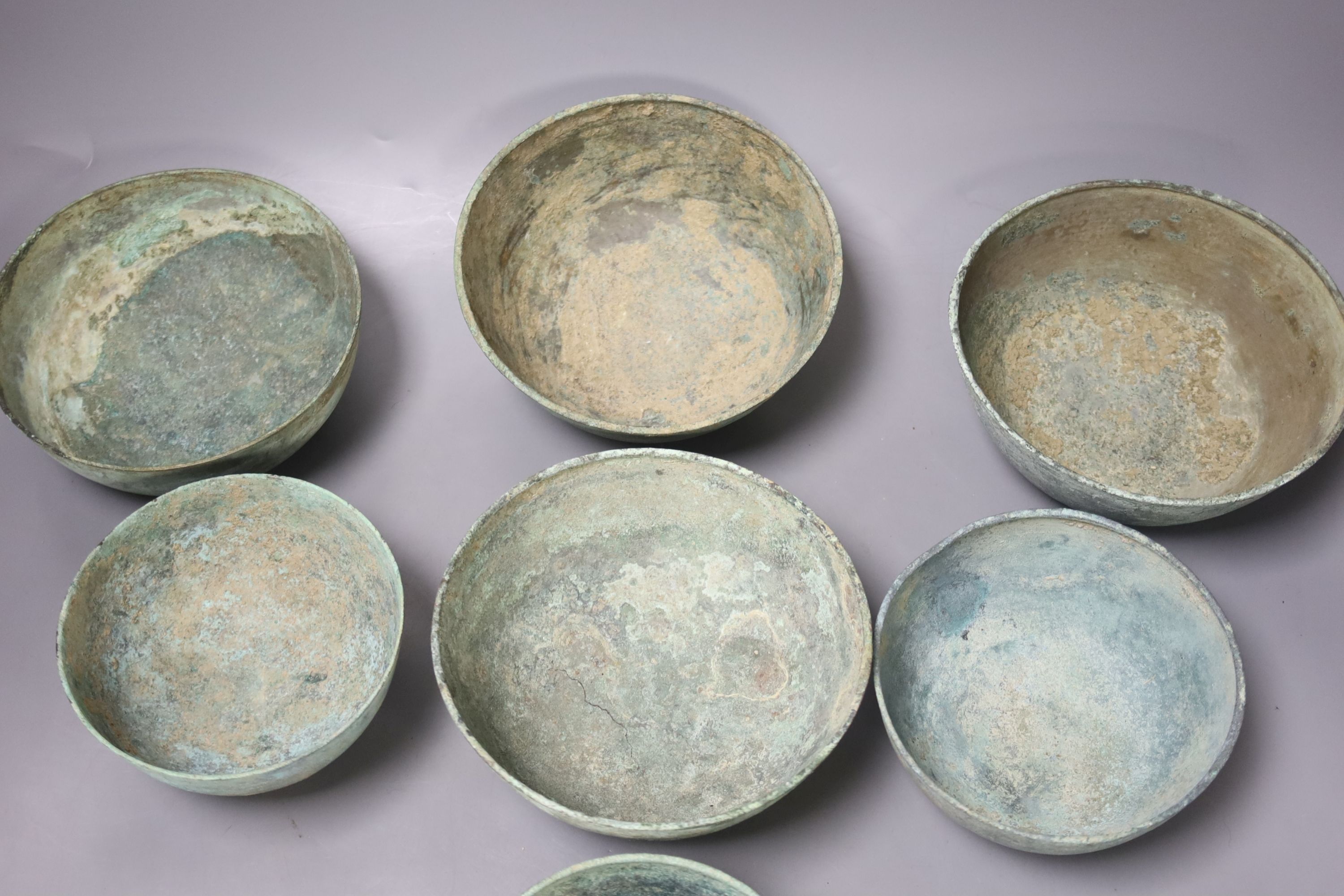 Seven Cambodian bronze ritual offering or water bowls, Khmer, 12th/13th century